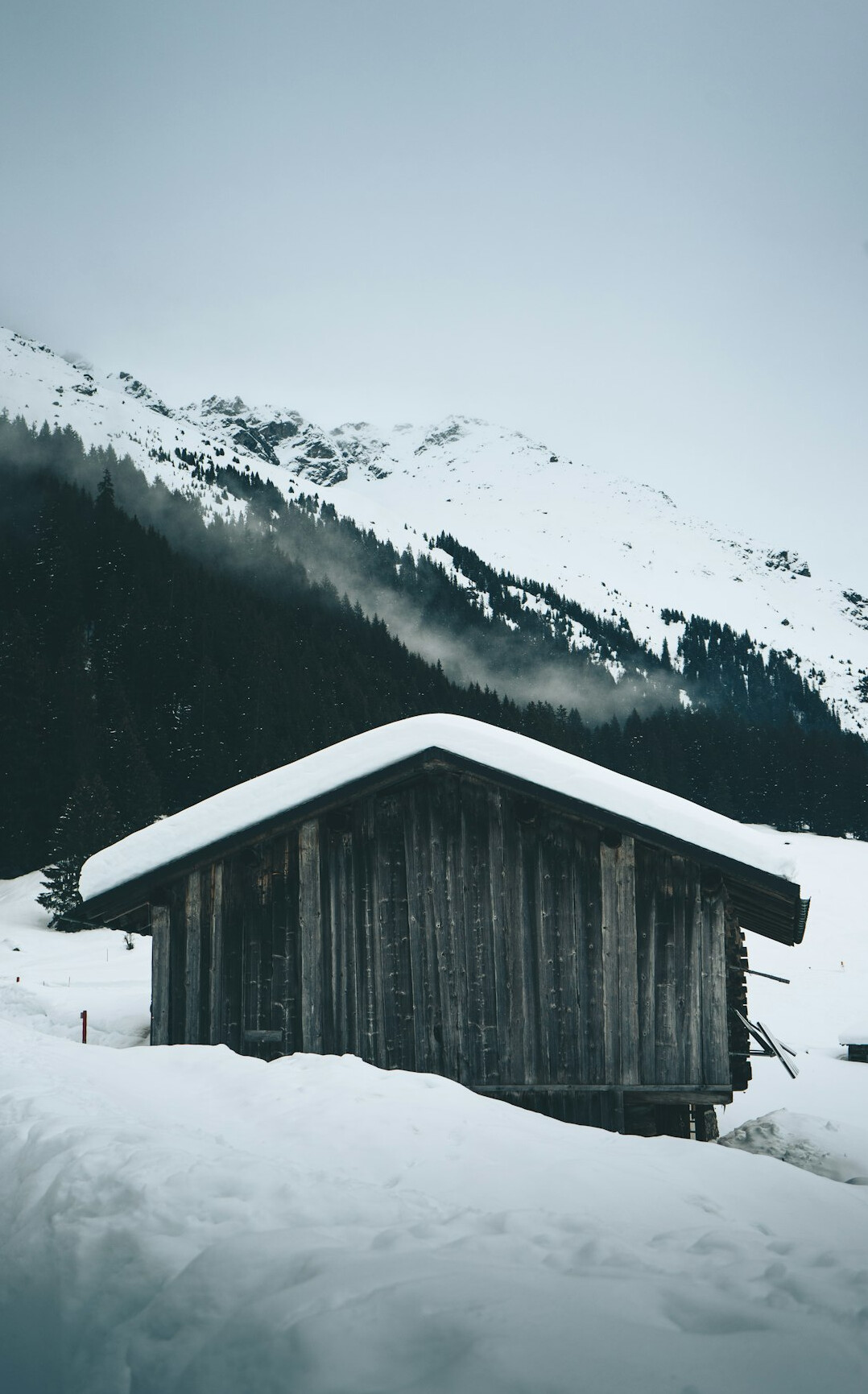 Wooden alpine chalet on a snowy mountainside in Switzerland