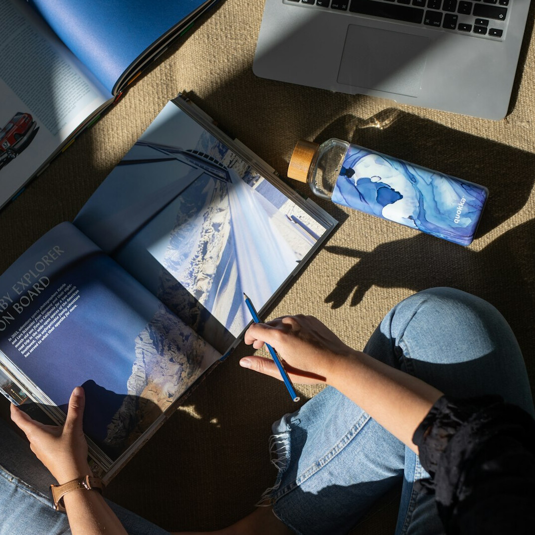 Small team of editors collaborating around a table with laptops